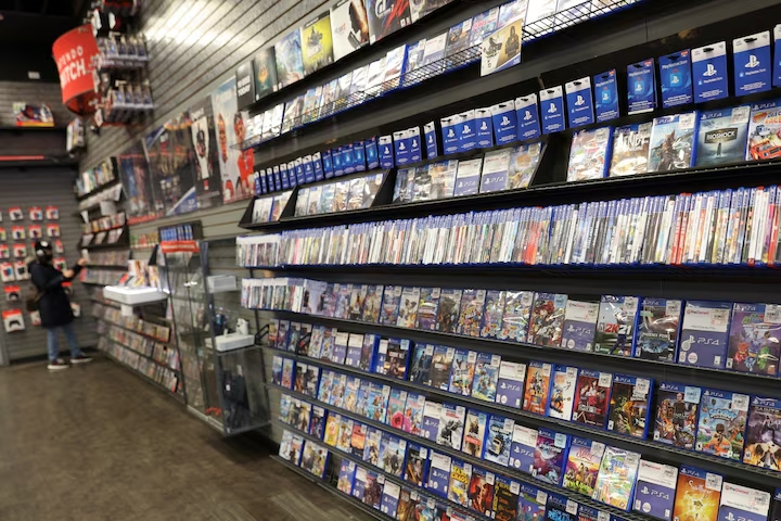 A shopper browses games at a GameStop store in Manhattan, New York, on December 7, 2021.
Image Source: Reuters